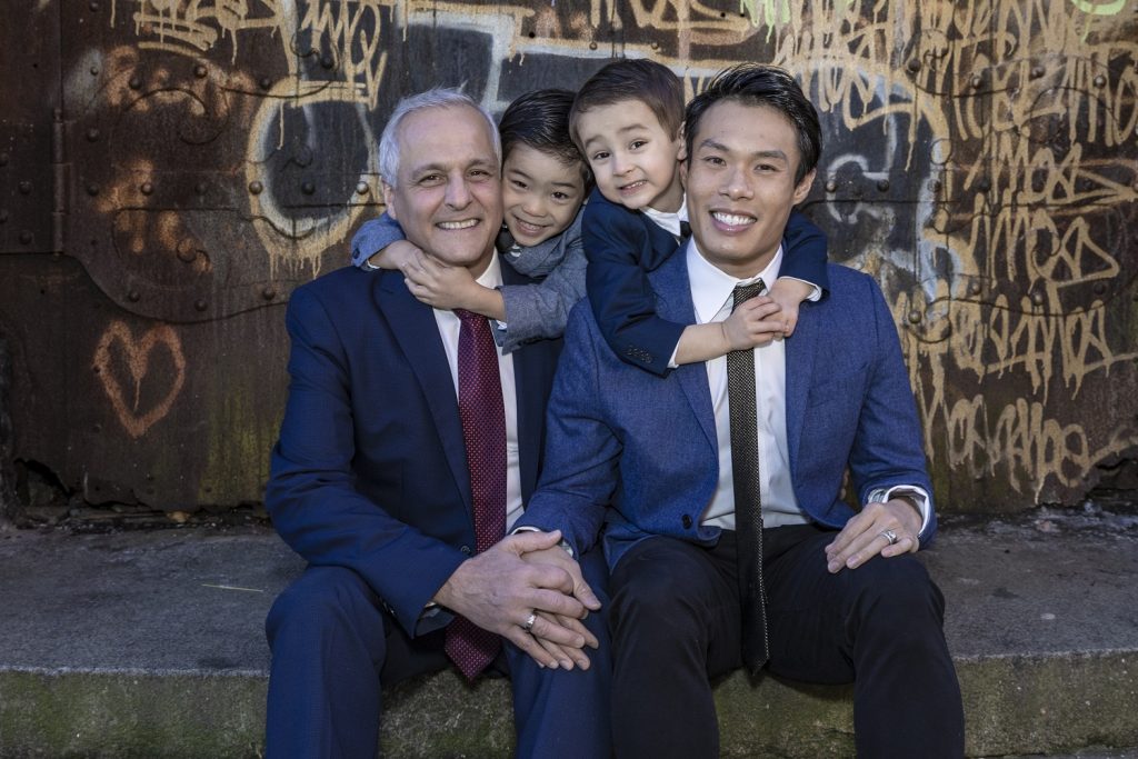 John Lam (right) with his husband and sons. - Photo by Alex Vainstien Photography