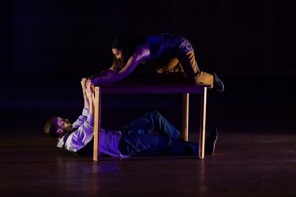 Invertigo Dance Theatre - Chelsea Roquero (top) Austin Tyson (under table) in The Kitchen Table: A Time to Gather - Photo by Denise Leitner